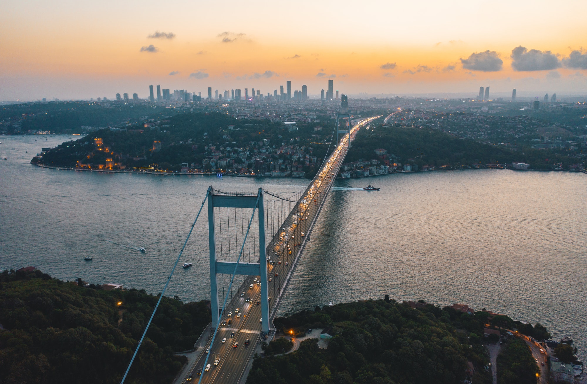 Istanbul Bosphorus Bridge at Sunset with Car traffic lights and City Skyline, Aerial View